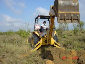 Employee Using a Back Hoe to Dig